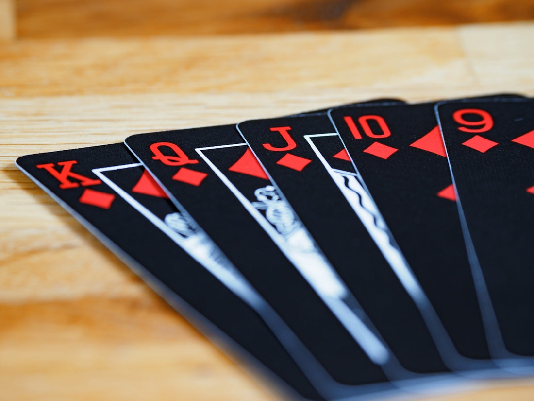 a group of playing cards sitting on top of a wooden table