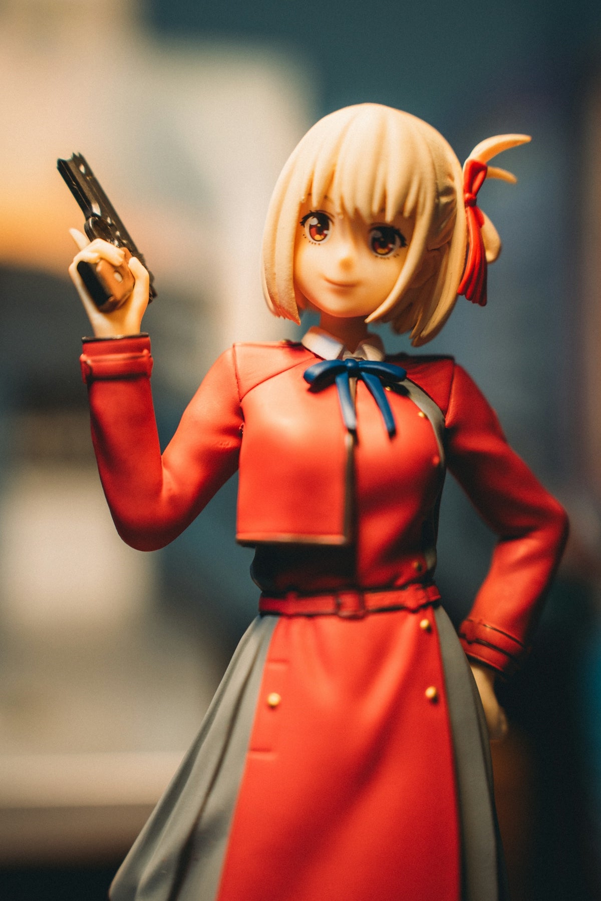 a close up of a doll holding a cell phone