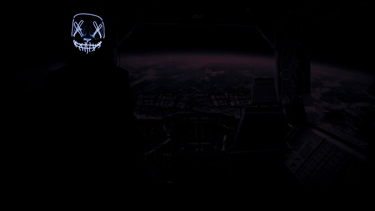 a person in a dark room with a mask on