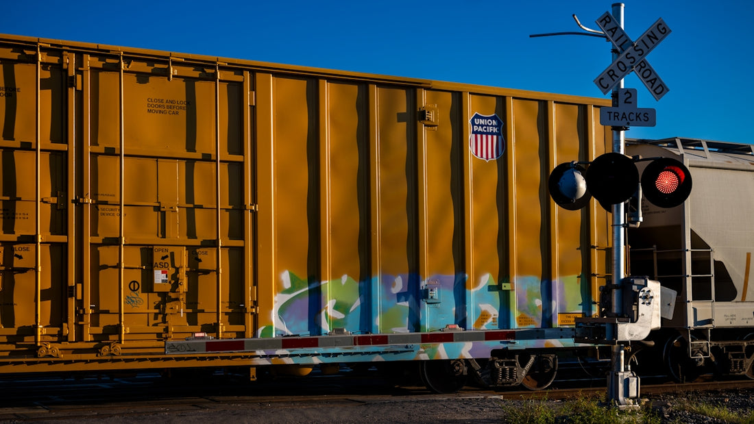A train traveling down train tracks next to a traffic light