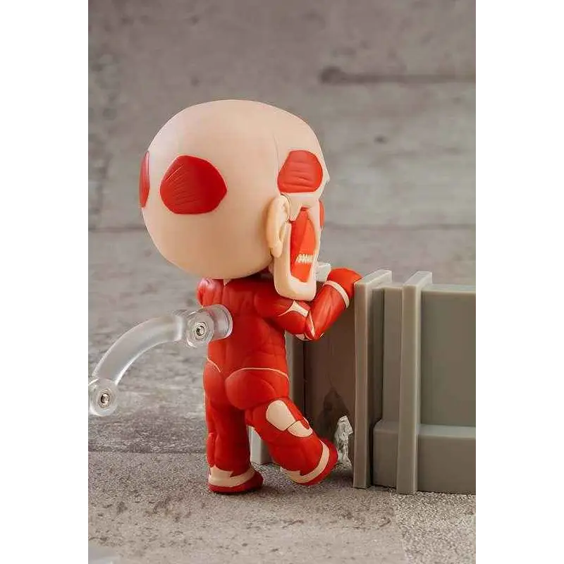 Röd och beige Nendoroid-figur av Colossal Titan från Attack on Titan, med detaljerad muskelanatomi och ledade lemmar