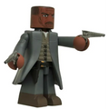 Detaljerad Vinimate-figur av Dark Towers Gunslinger från Stephen King, med brun hy och skägg, grå kappa, beige väst, mörka byxor och två silverrevolvrar