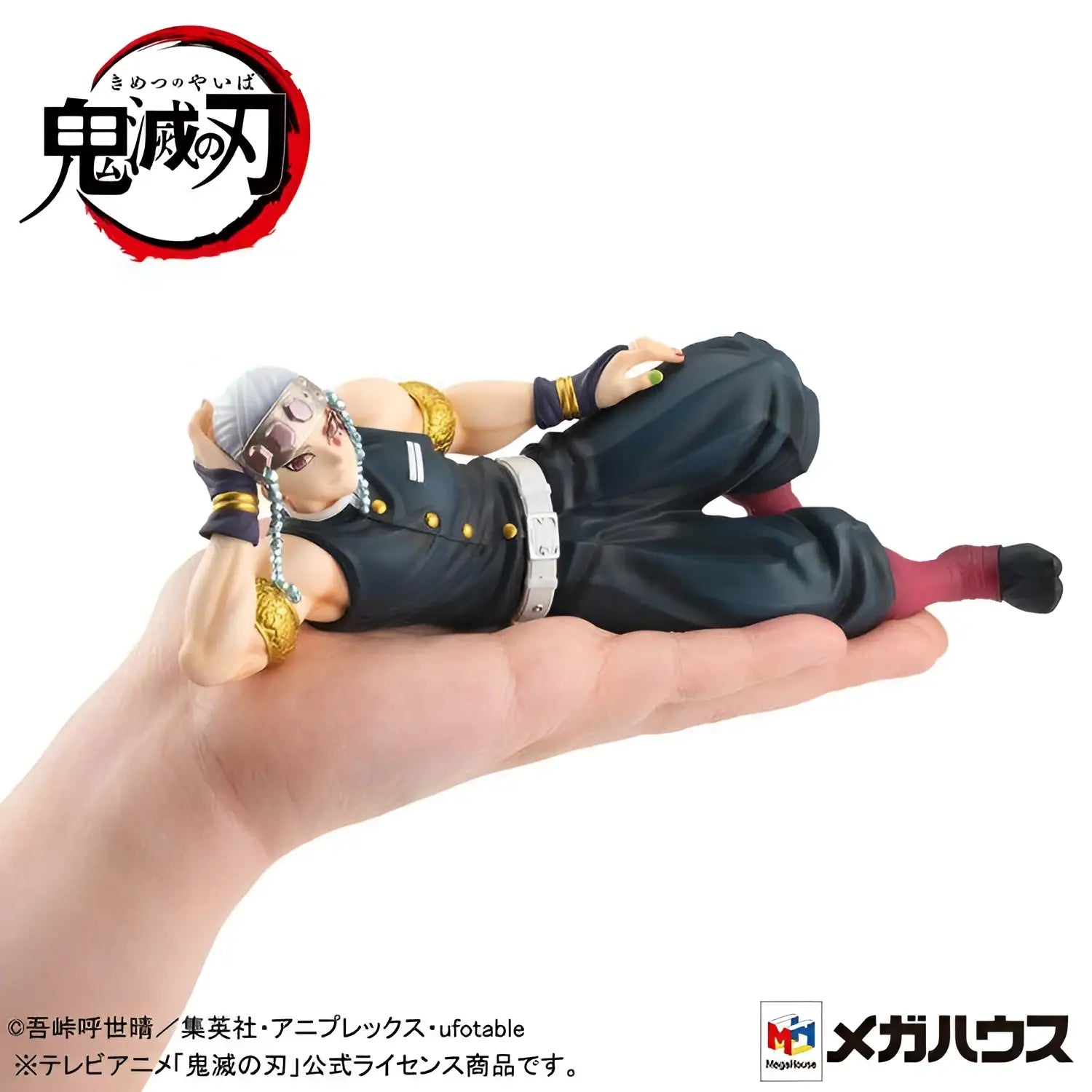 Detaljerad svart och guldfigur av Uzui från Demon Slayer, liggande på rygg med handen bakom huvudet