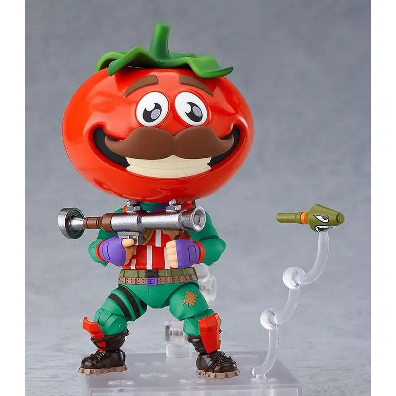 Fortnite Tomato Head Nendoroid-figur med röd tomat-huvud, grön stjälk, brun mustasch, tecknade ögon och silvergevär