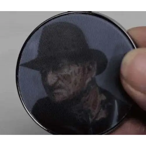 Freddy Krueger i svart-silver ramad cirkulär lentikulär nyckelring med Freddy vs Jason-motiv