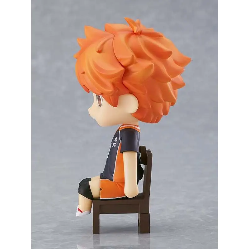 Chibi Shoyo Hinata nendoroid swacchao i orange-hår, svart-orange volleybolluniform, sittande på brun stol