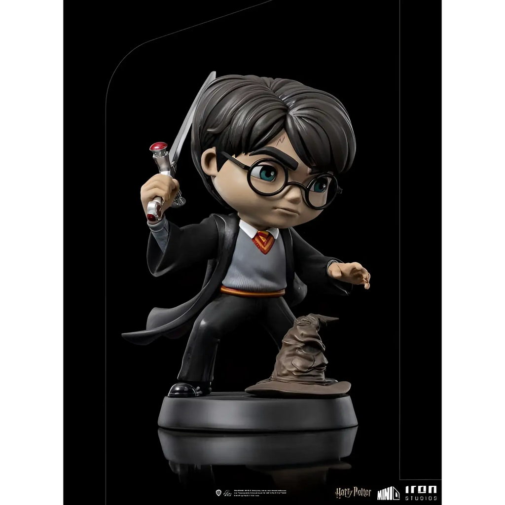 Chibi Harry Potter figurin i svarta robes med grå tröja och röd-guld slips, håller trollstav med glödande spets