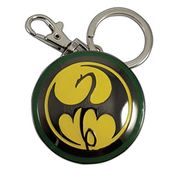 Grön och gul rund nyckelring med stiliserad fladdermusemblem, Iron Fist Logotyp