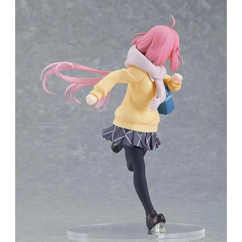 Nadeshiko Kagamihara från Laid-back Camp: rosa hår, gul hoodie, mönstrad kjol, svarta strumpbyxor, isskridskor, vit scarf och blå väska