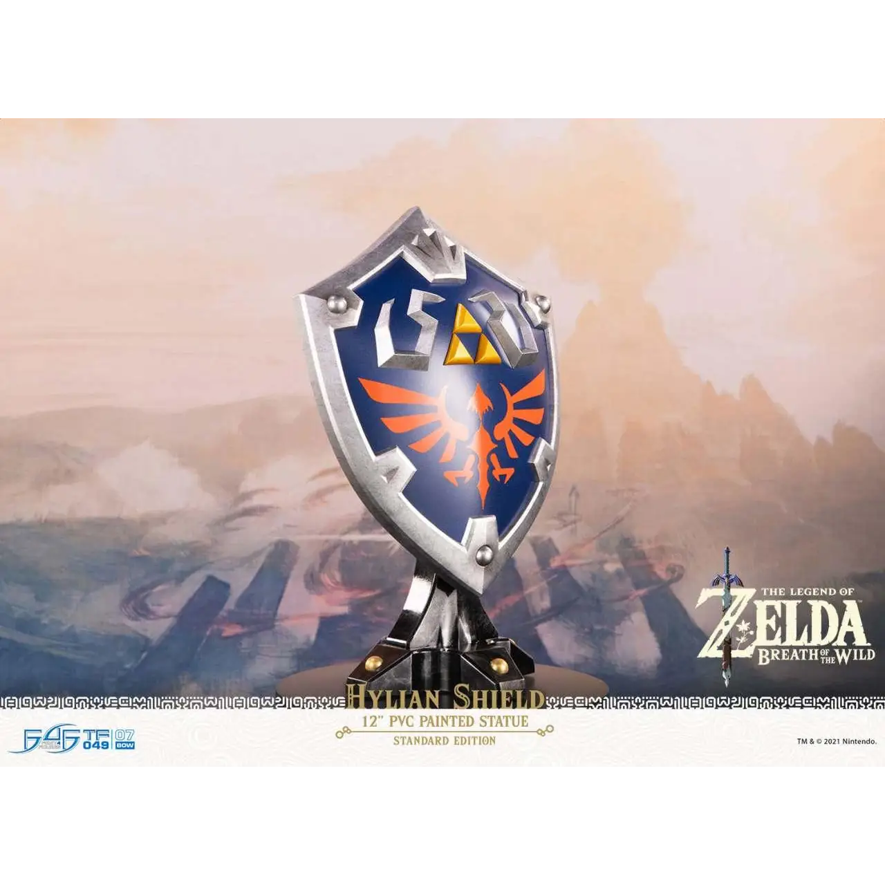 Silver and blue Hylian shield statue from The Legend of Zelda: Breath of the Wild, with gold Triforce and orange bird