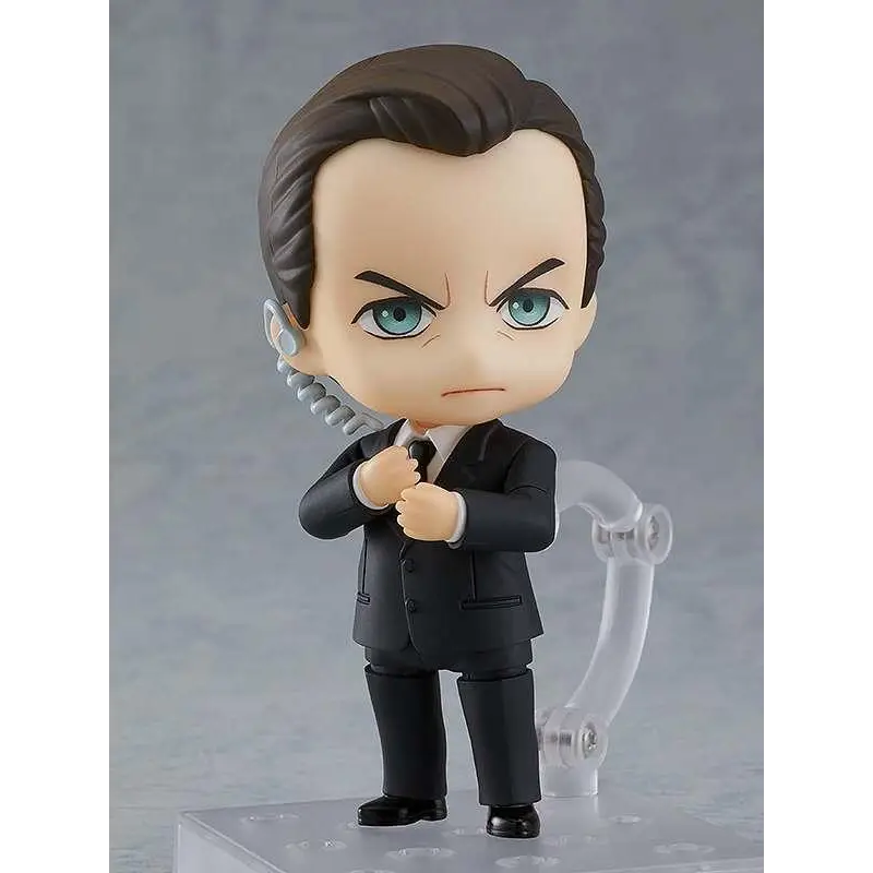 Nendoroid Agent Smith från The Matrix med svart kostym, brun hår och turkosa ögon, håller i hoprullad telefonlur