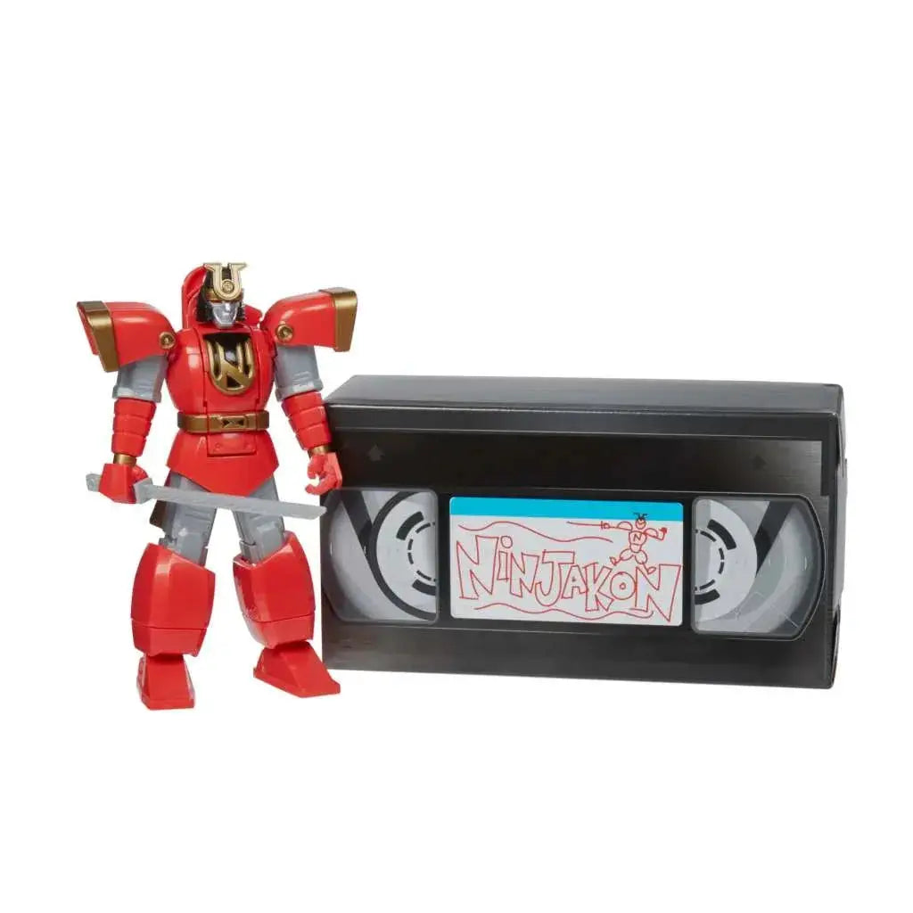 Röd och gul pansrad robotfigur med svärd bredvid svart VHS-band märkt Ninjakon, Power Rangers LC Ltd Edition