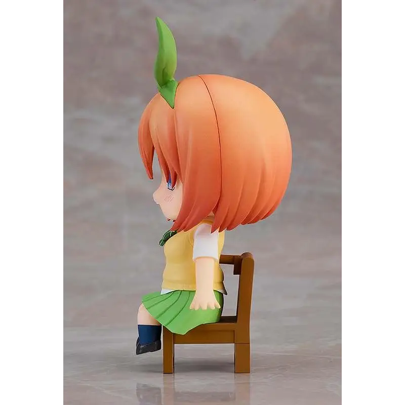 Orange-haired chibi Quint Yotsuba Nendoroid Swacchao! figurine with green leaf accessory, yellow top and green pleated skirt