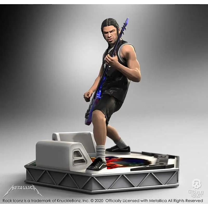Svartlila metallfigur av Robert Trujillo från Metallica med gitarr på scenbas