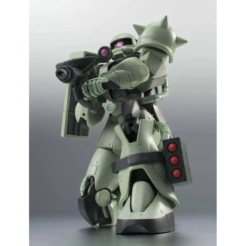 Olivgrön och svart plastmodell av Zaku II från Gundam, med spikad hjälm