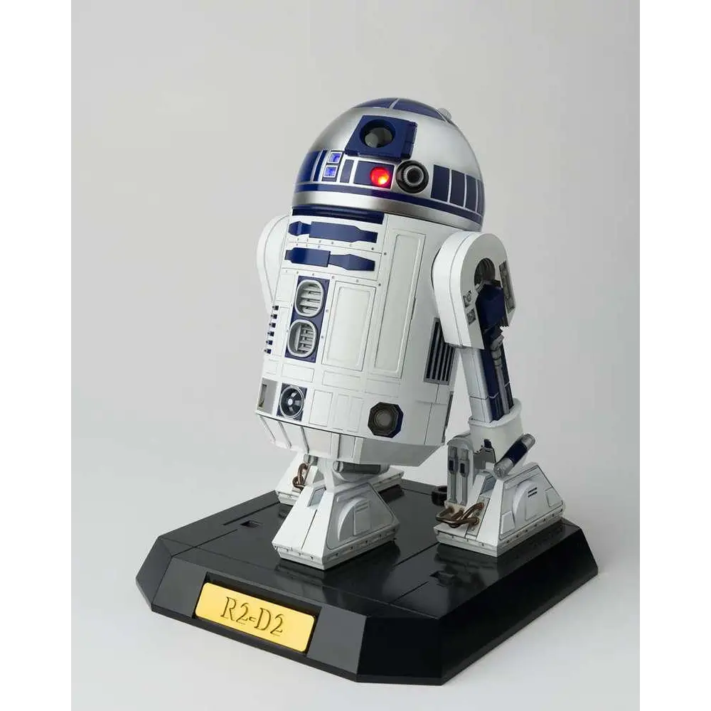 Vit svart och blå R2-D2 Chogokin diecast-figur med detaljerad panelning, rött öga och metallisk finish på svart bas