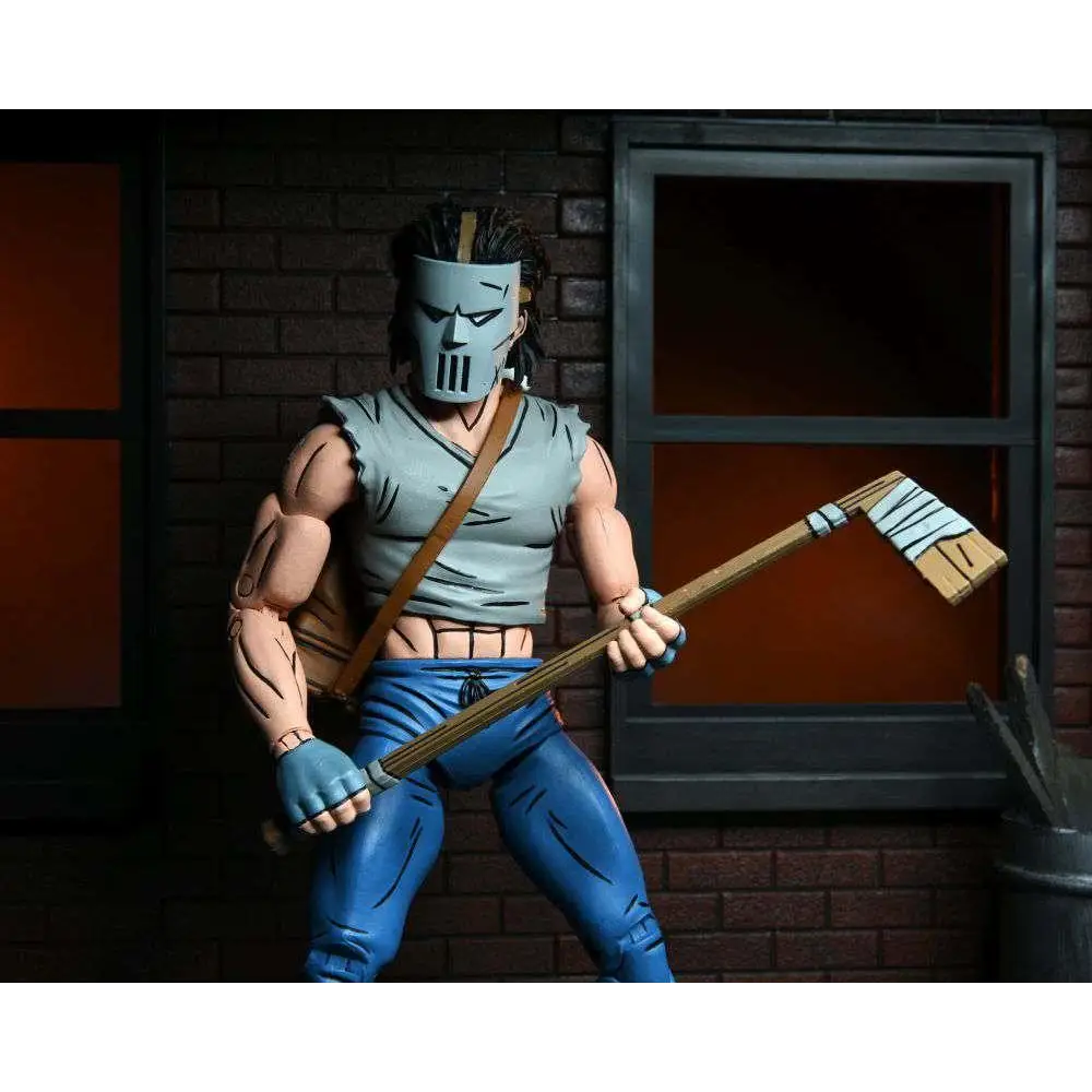 Detaljerad TMNT Mirage Comics Casey Jones actionfigur med grå mask, ljusblå tröja och byxor, håller yxa