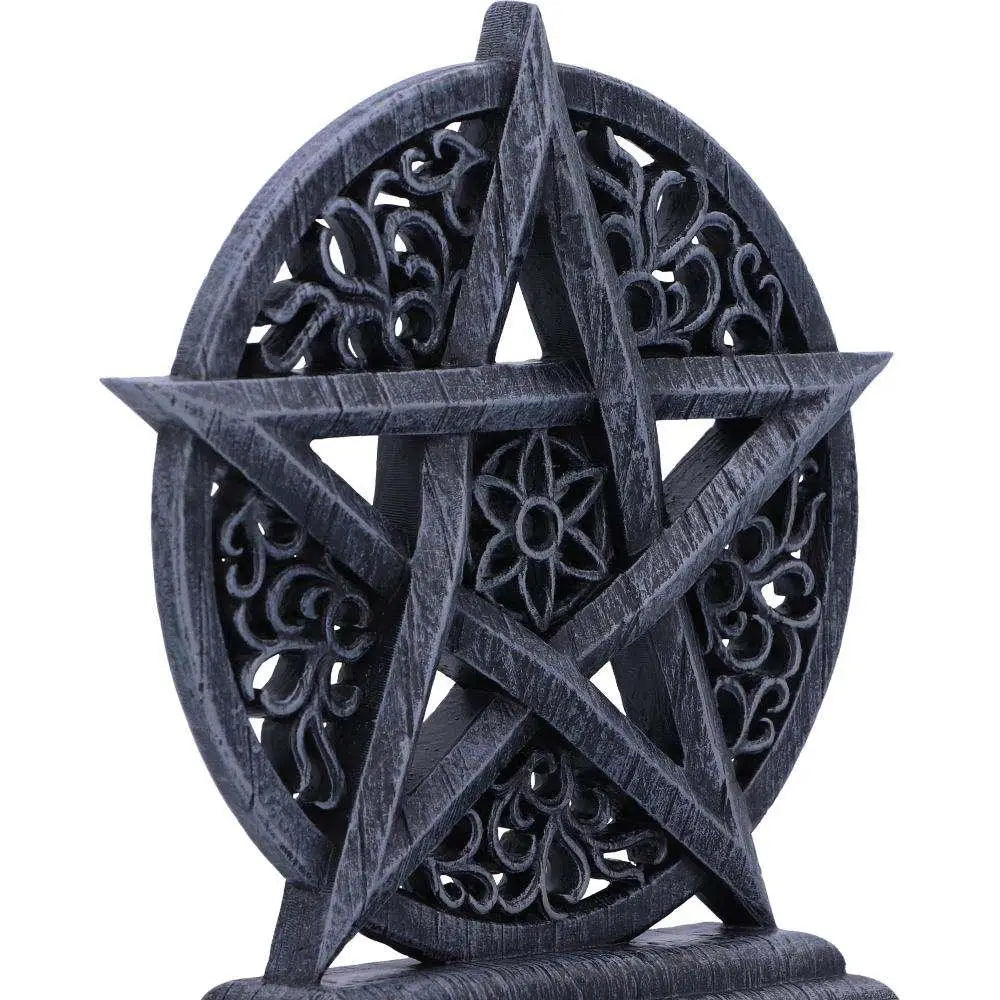 Mörkgrå intrikat snidad pentagramstaty med ornamentala blommotiv och rustik textur