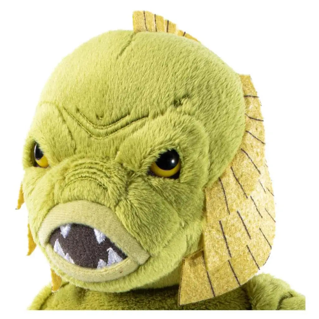 Grön plushleksak Universal Monsters Creature med gula ögon och vit tandad mun