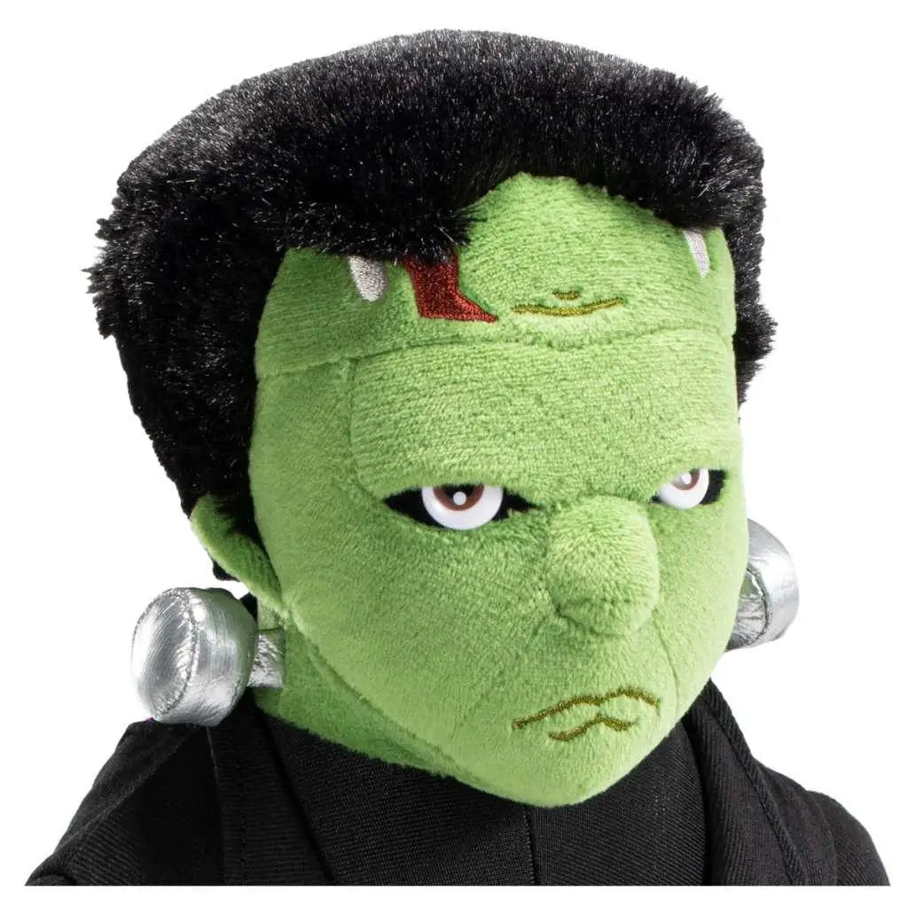 Grön plyschig Frankenstein-ducka med svart fuzzigt hår, silverbultar på öronen och broderade ansiktsdrag från Universal Monsters