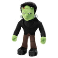 Grön plysch Frankenstein-monsterdocka med svart hår och silverbultar i öronen, klädd i svart kostym och bruna byxor från Universal Monsters